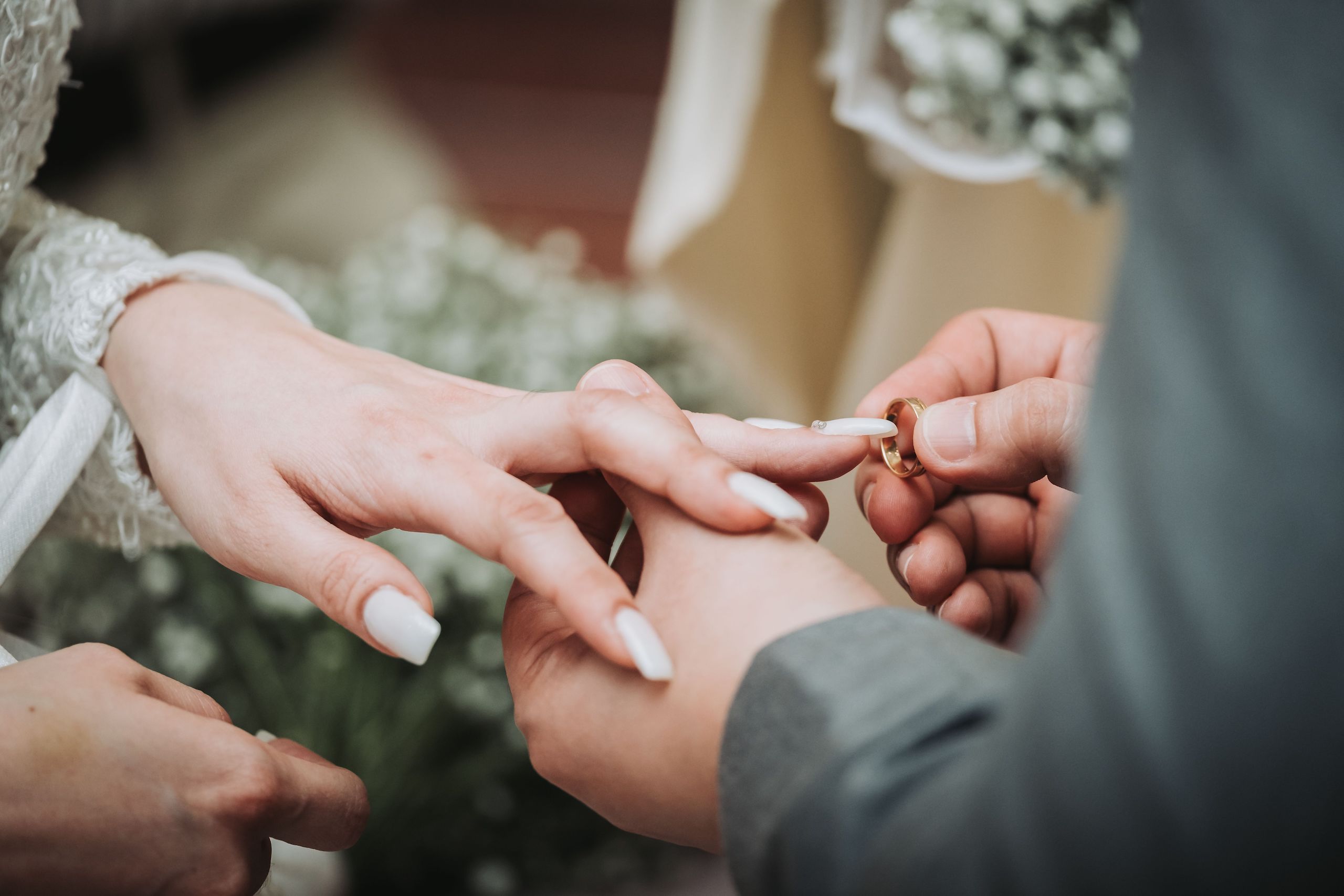 Couple exchanges rings at wedding ceremony.
